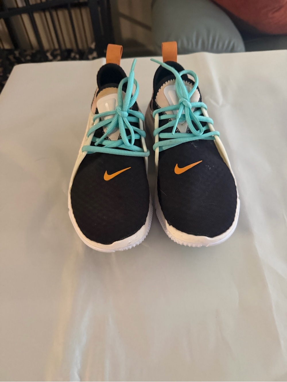 Nike Black Sneakers with Teal Laces and Orange Swoosh Accent